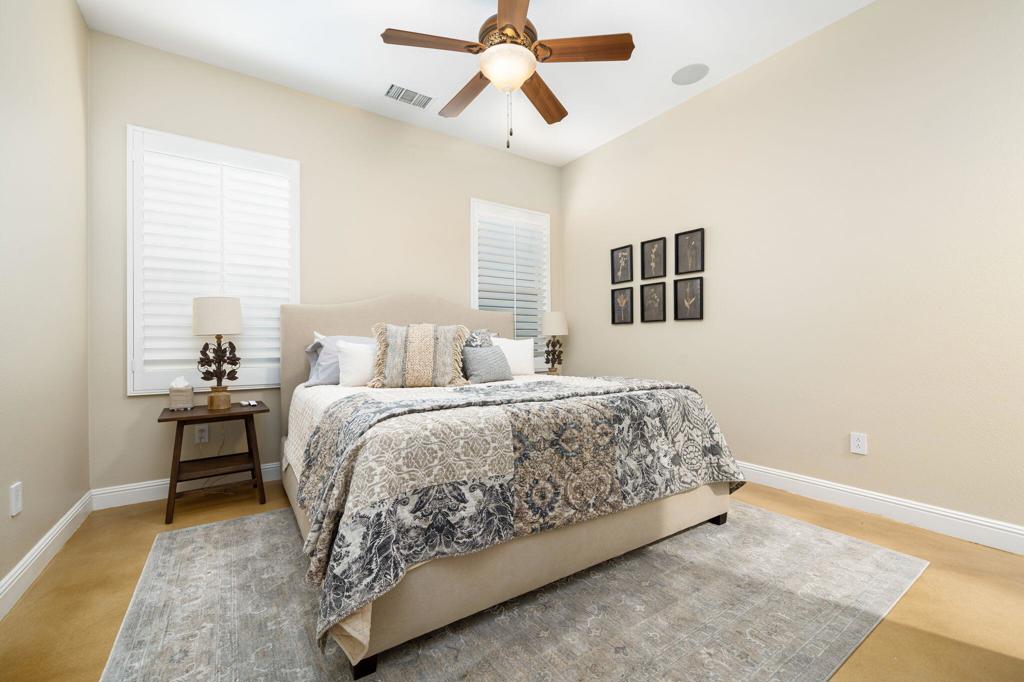 56495 Mountain La La Quinta, CA 92253 - Photo 46 of 56 a bedroom with a bed and a chandelier