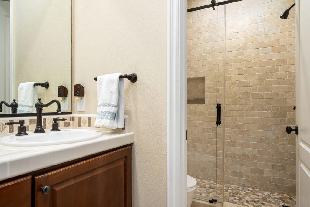 56495 Mountain La La Quinta, CA 92253 - Photo 47 of 56 a bathroom with a double vanity sink a shower and a mirror