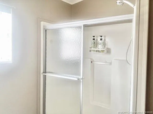 a bathroom with a glass shower door