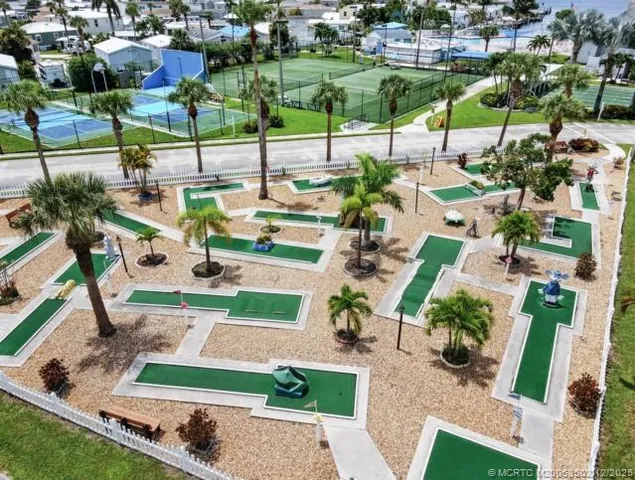 an aerial view of residential houses with outdoor space and street view