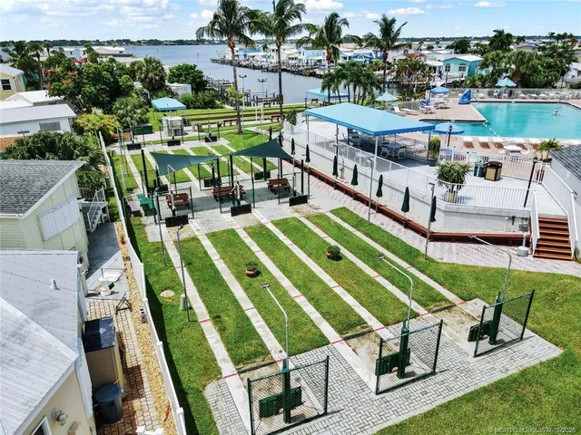 an aerial view of a house with a yard outdoor seating