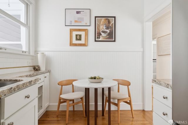 a view of a dining room with furniture and wooden floor