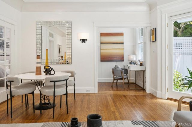 a view of a dining room with furniture and a large window
