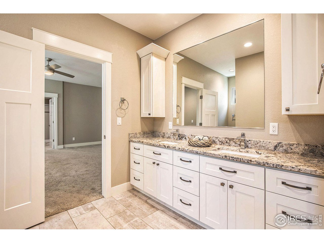 1100 Johnson Street Wiggins, CO 80654 - Photo 12 of 34 a bathroom with a granite countertop sink mirror and