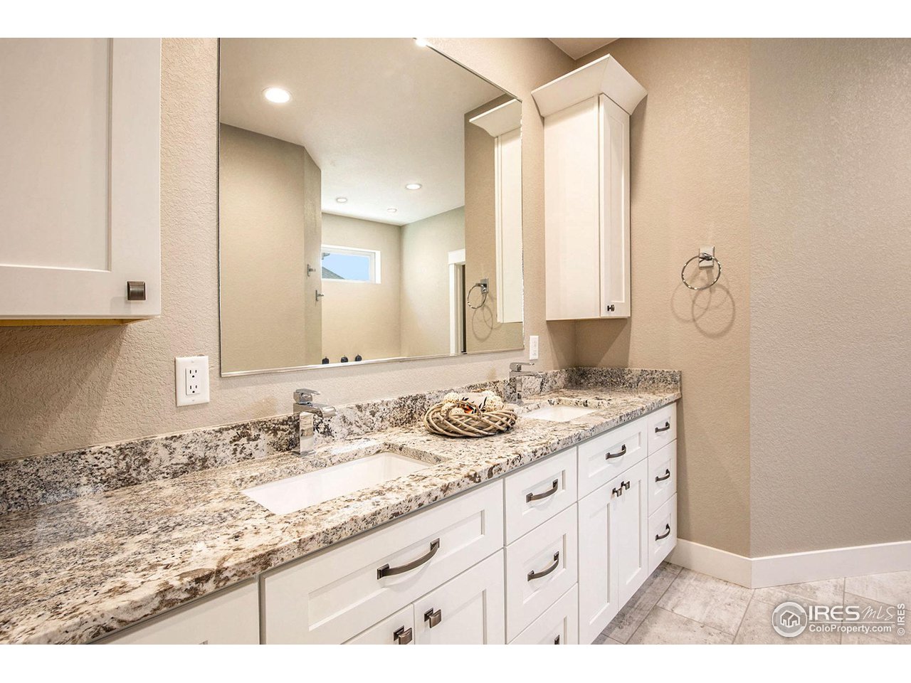 1100 Johnson Street Wiggins, CO 80654 - Photo 13 of 34 a bathroom with a granite countertop sink and a mirror