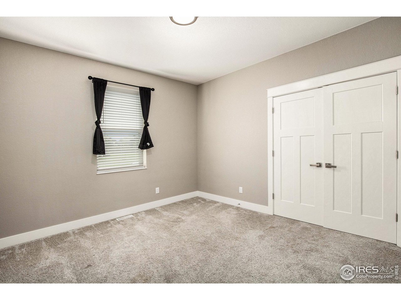 1100 Johnson Street Wiggins, CO 80654 - Photo 19 of 34 a view of an empty room with window and closet area