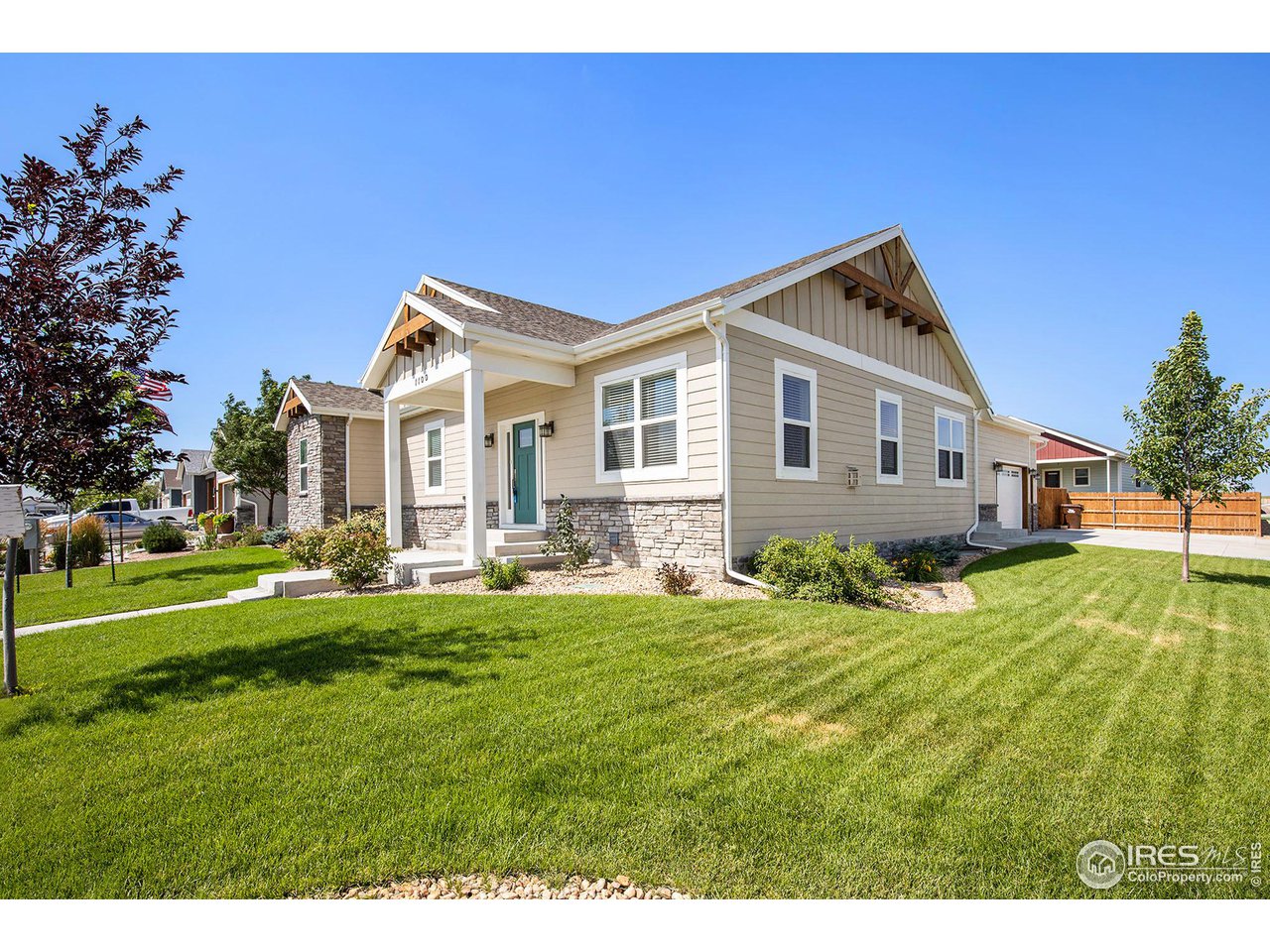 1100 Johnson Street Wiggins, CO 80654 - Photo 2 of 34 a front view of a house with a yard table and chairs