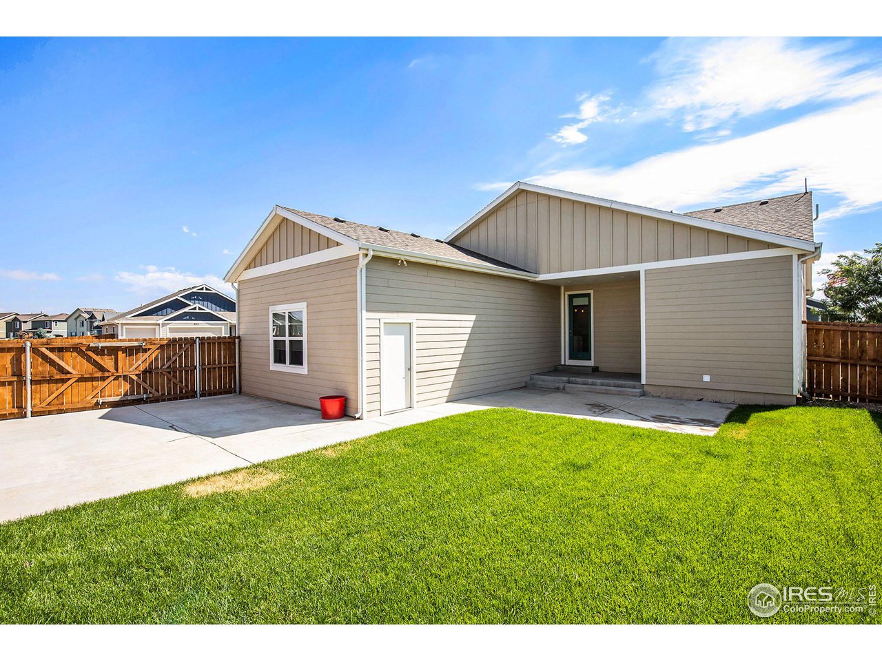 1100 Johnson Street Wiggins, CO 80654 - Photo 30 of 34 a front view of a house with a yard and garage