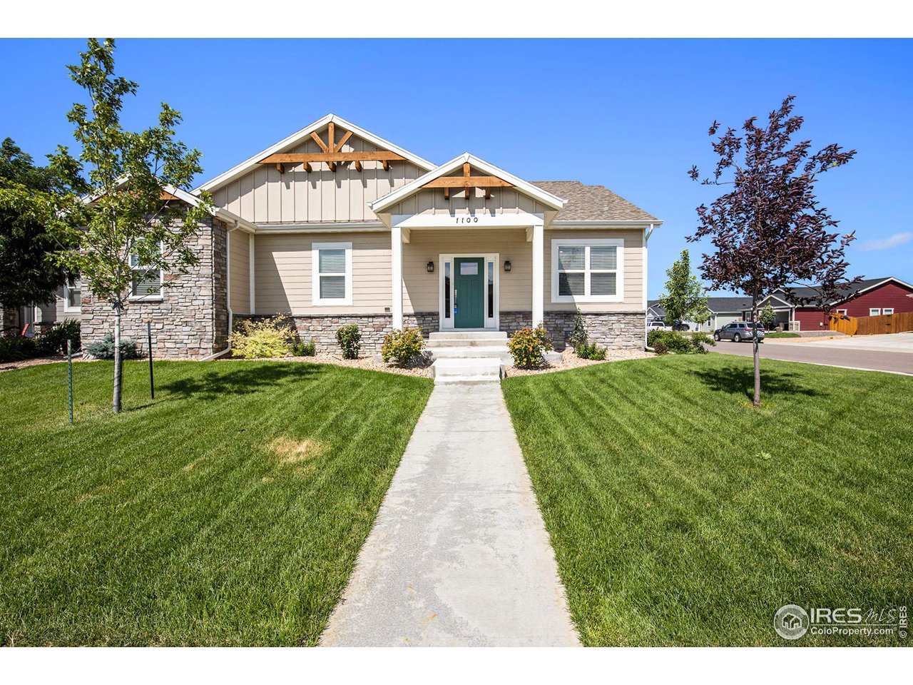 1100 Johnson Street Wiggins, CO 80654 - Photo 3 of 34 a front view of a house with a yard