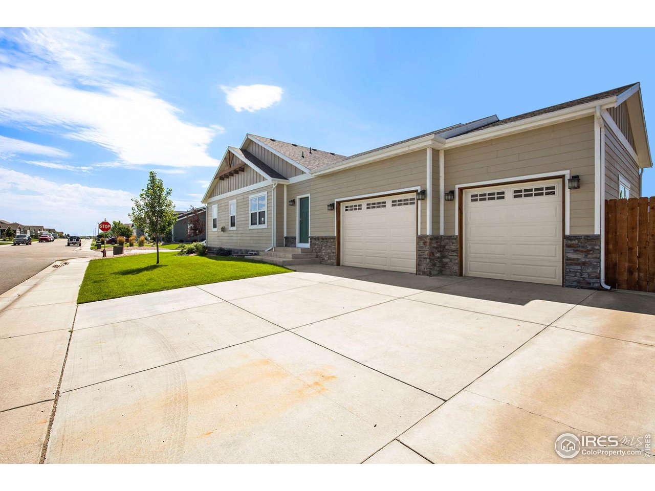1100 Johnson Street Wiggins, CO 80654 - Photo 31 of 34 a front view of a house with a yard and garage
