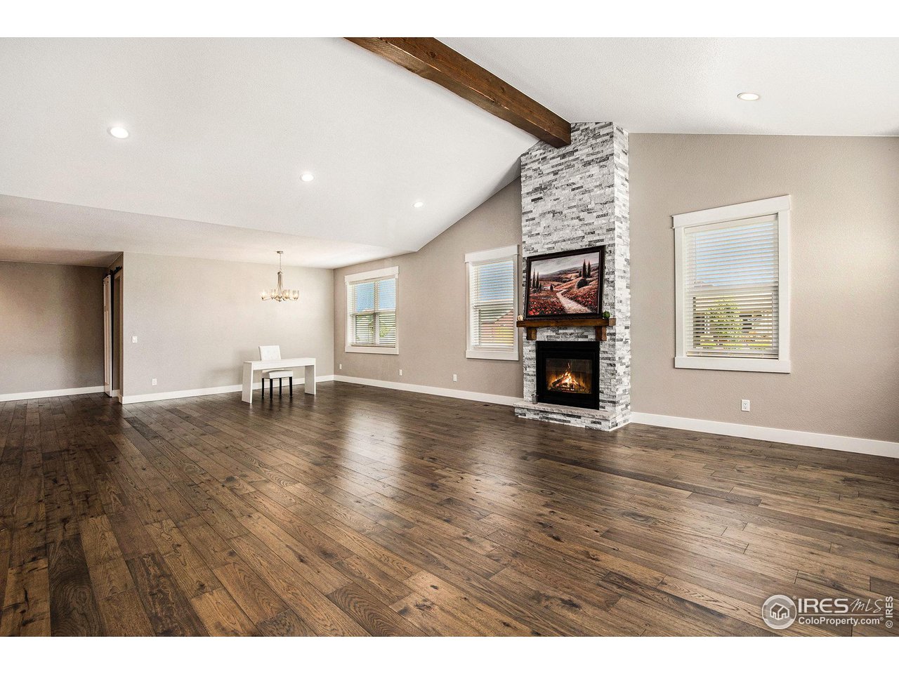 1100 Johnson Street Wiggins, CO 80654 - Photo 5 of 34 a view of a livingroom with furniture wooden floor fireplace and windows