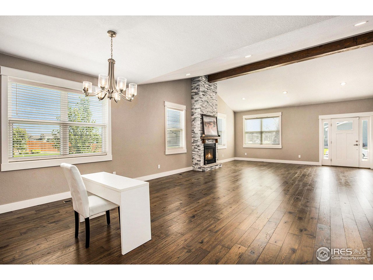 1100 Johnson Street Wiggins, CO 80654 - Photo 6 of 34 a view of a dining room with furniture wooden floor and chandelier