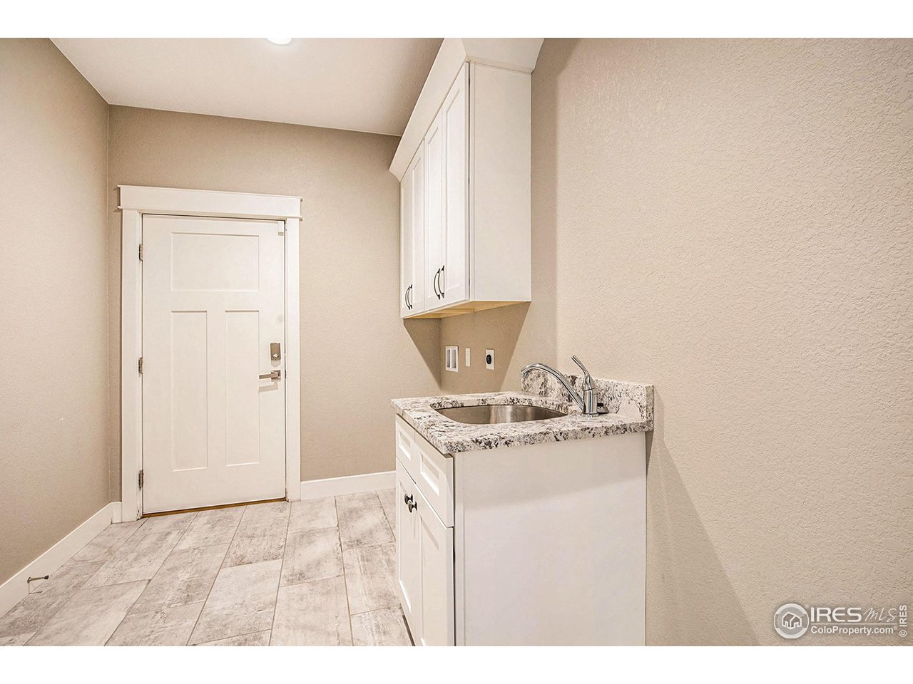 1100 Johnson Street Wiggins, CO 80654 - Photo 10 of 34 a kitchen with a stove and a white cabinet