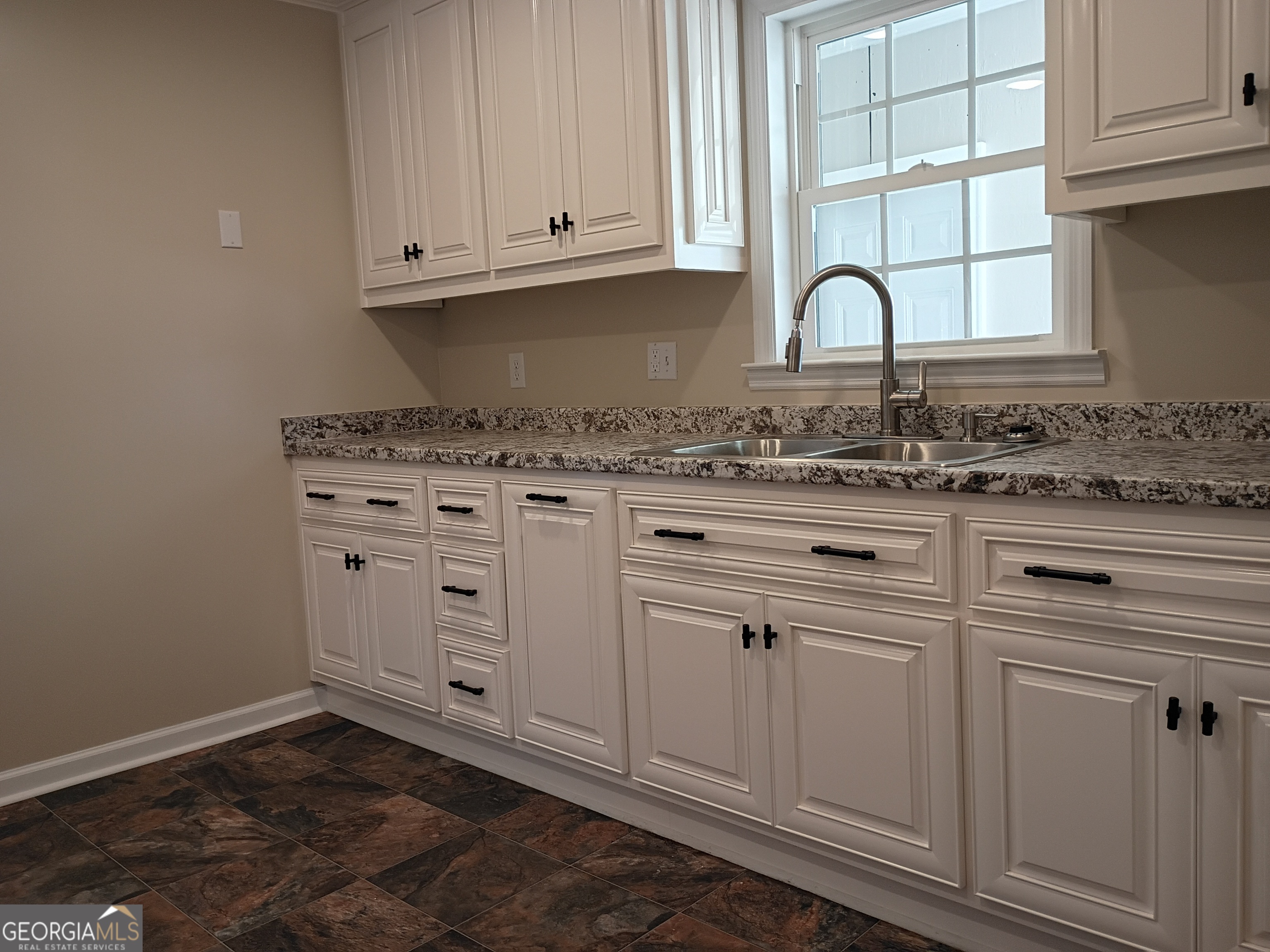 624 Thompson Road Swainsboro, GA 30401 - Photo 7 of 20 a kitchen with white cabinets and sink