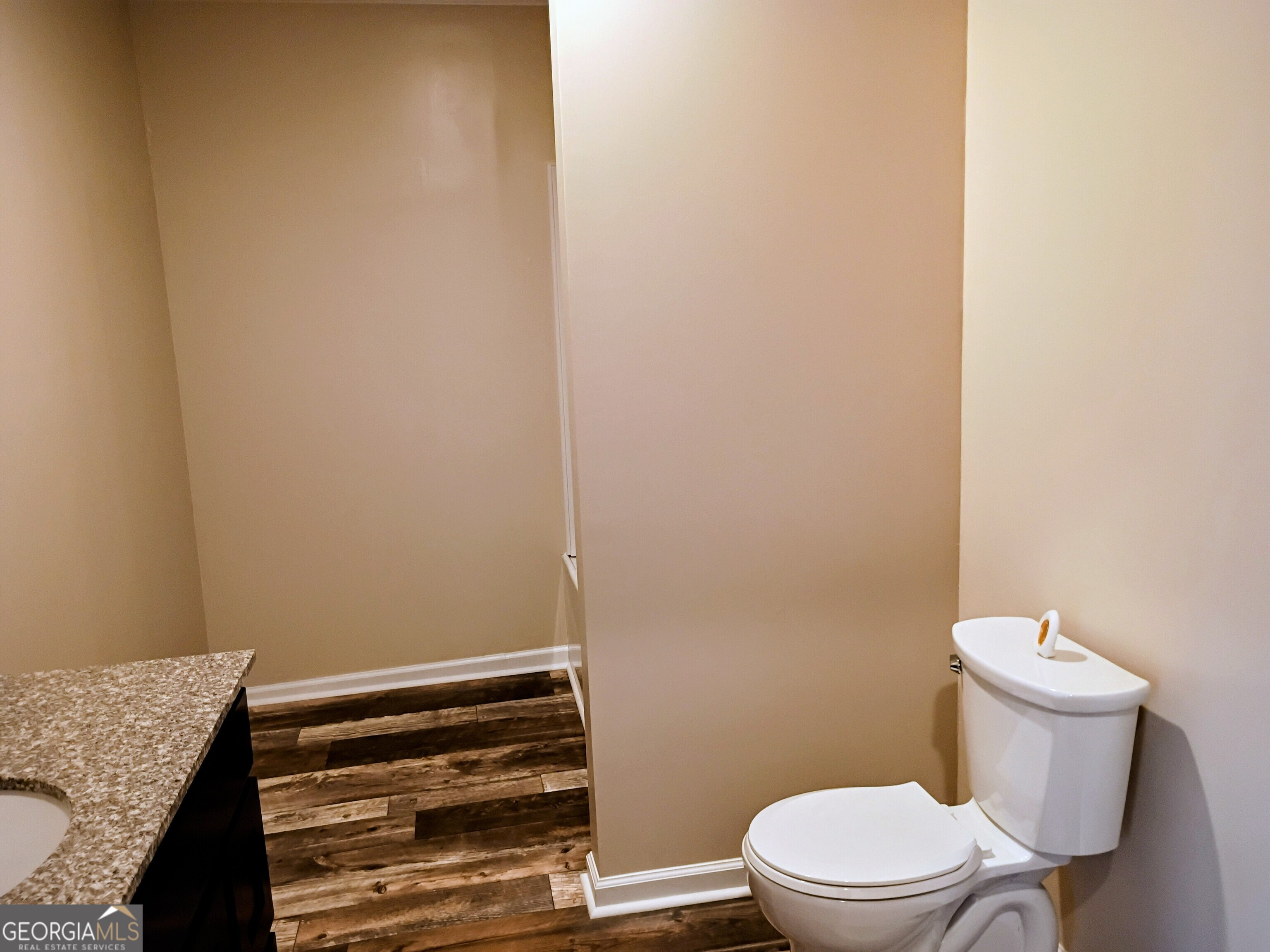 624 Thompson Road Swainsboro, GA 30401 - Photo 8 of 20 a bathroom with a granite countertop toilet and a sink