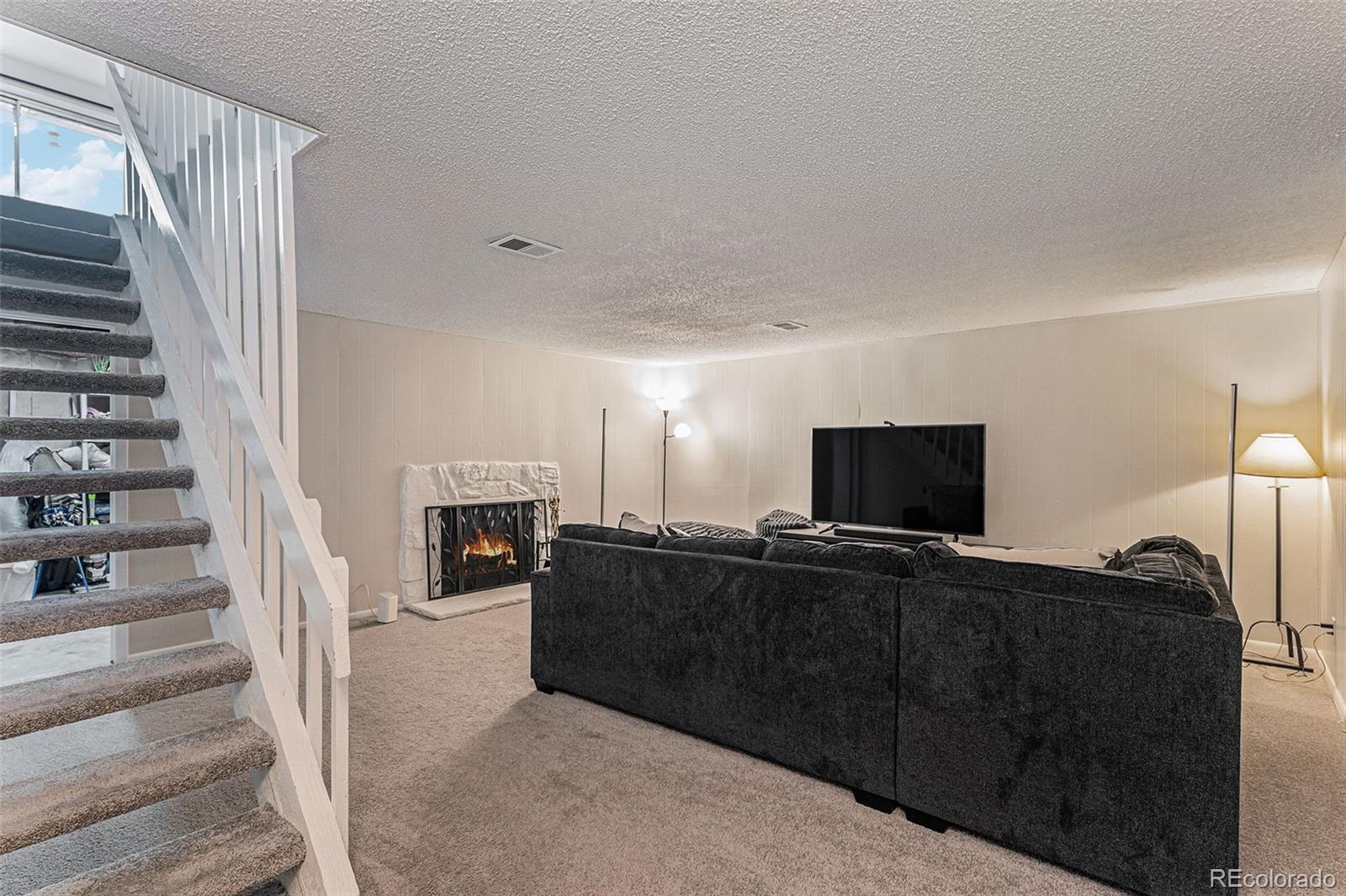 4262 East Maplewood Way Centennial, CO 80121 - Photo 16 of 32 a view of a livingroom with furniture and a fireplace