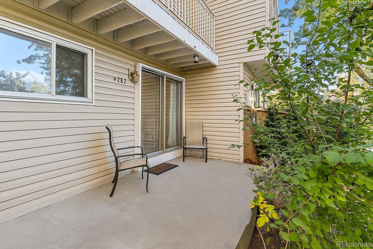 4262 East Maplewood Way Centennial, CO 80121 - Photo 18 of 32 a view of a chair and table in backyard of the house