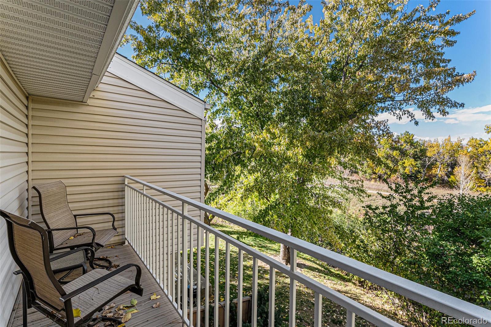 4262 East Maplewood Way Centennial, CO 80121 - Photo 19 of 32 a view of a balcony with wooden fence and floor
