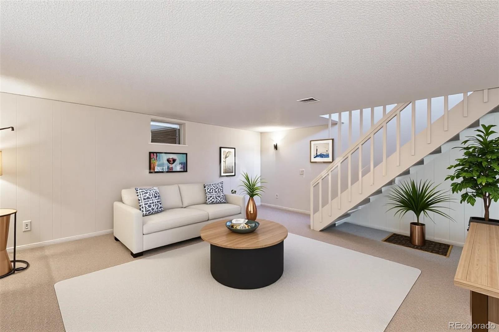 4262 East Maplewood Way Centennial, CO 80121 - Photo 2 of 32 a living room with furniture and a potted plant