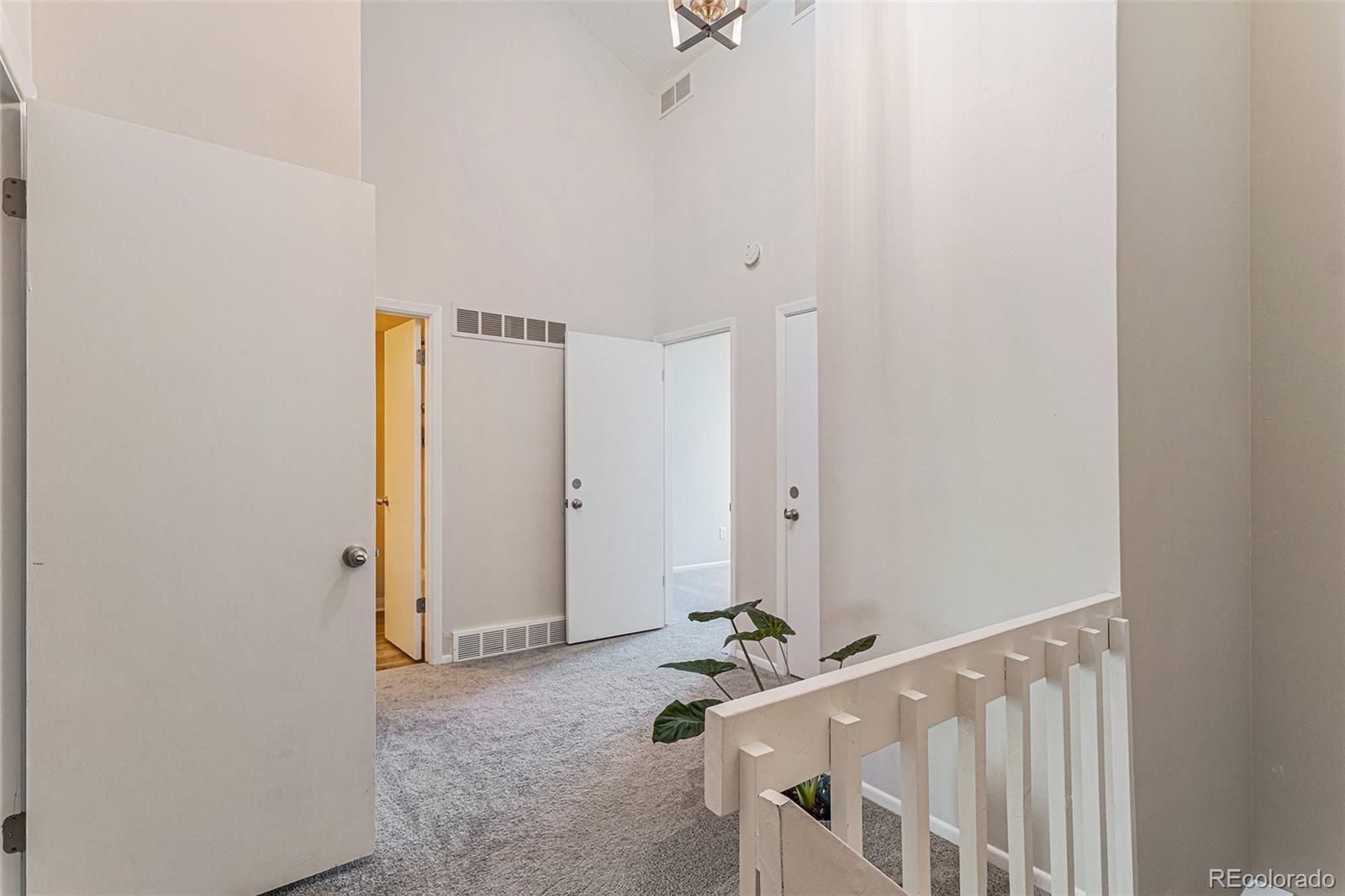 4262 East Maplewood Way Centennial, CO 80121 - Photo 8 of 32 a view of an entryway with staircase