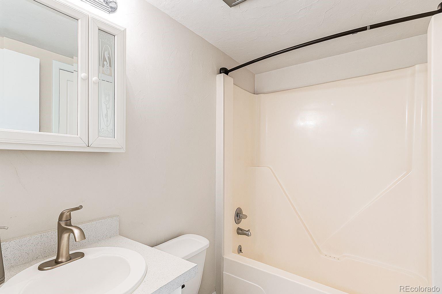 4262 East Maplewood Way Centennial, CO 80121 - Photo 10 of 32 a bathroom with a sink and a mirror