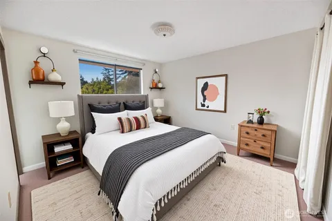 an empty room with a painting on the wall