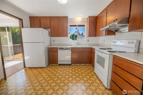 a kitchen with a stove a sink and a refrigerator