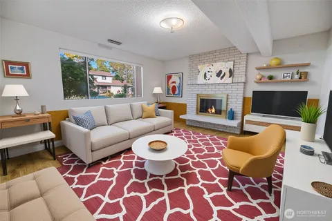 a bedroom with a bed plant and a couch