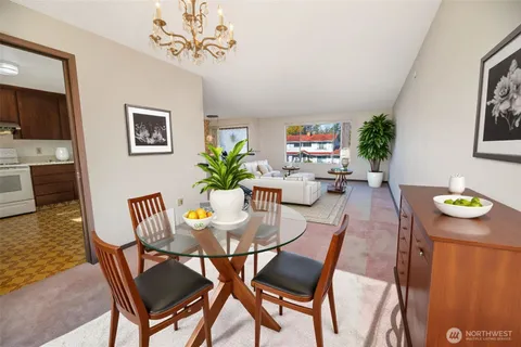 a view of a dining room with furniture and a potted plant