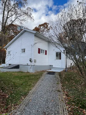 a backyard of a house with lots of green space