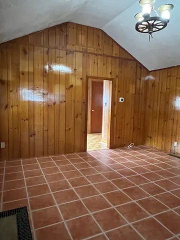 a view of a room with a wooden door