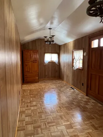 an empty room with windows and closet