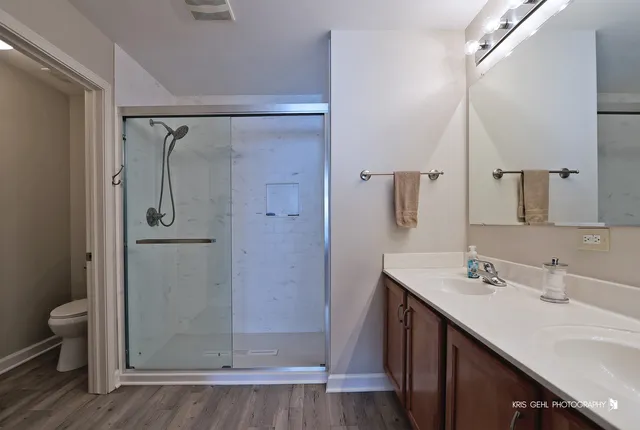 a bathroom with a shower sink and mirror
