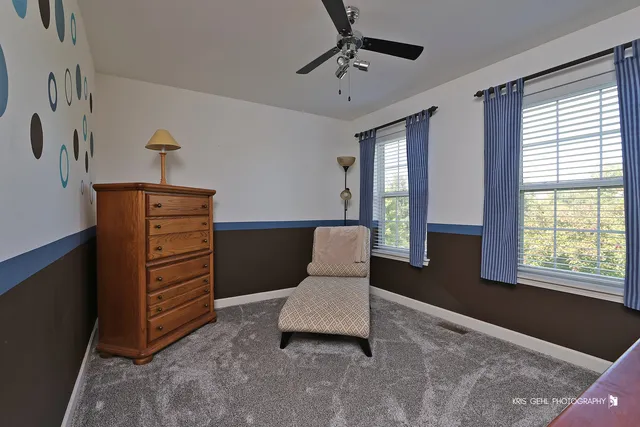 a living room with furniture and two windows