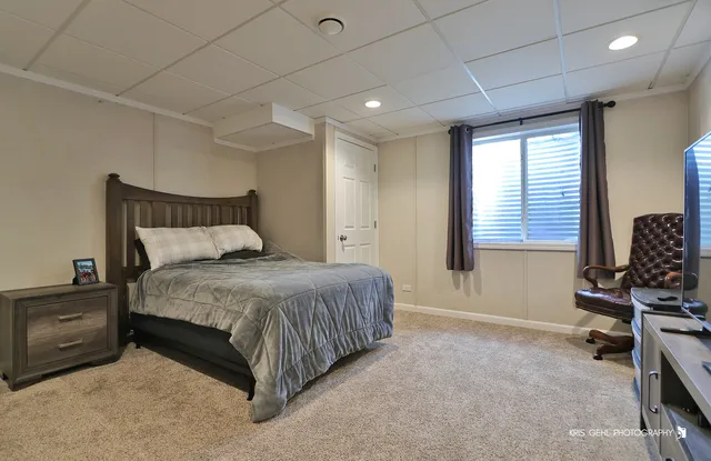a spacious bedroom with a bed a desk and chair