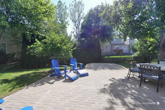 a view of backyard with outdoor seating and trees