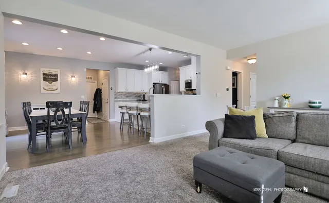 a living room with furniture and kitchen view