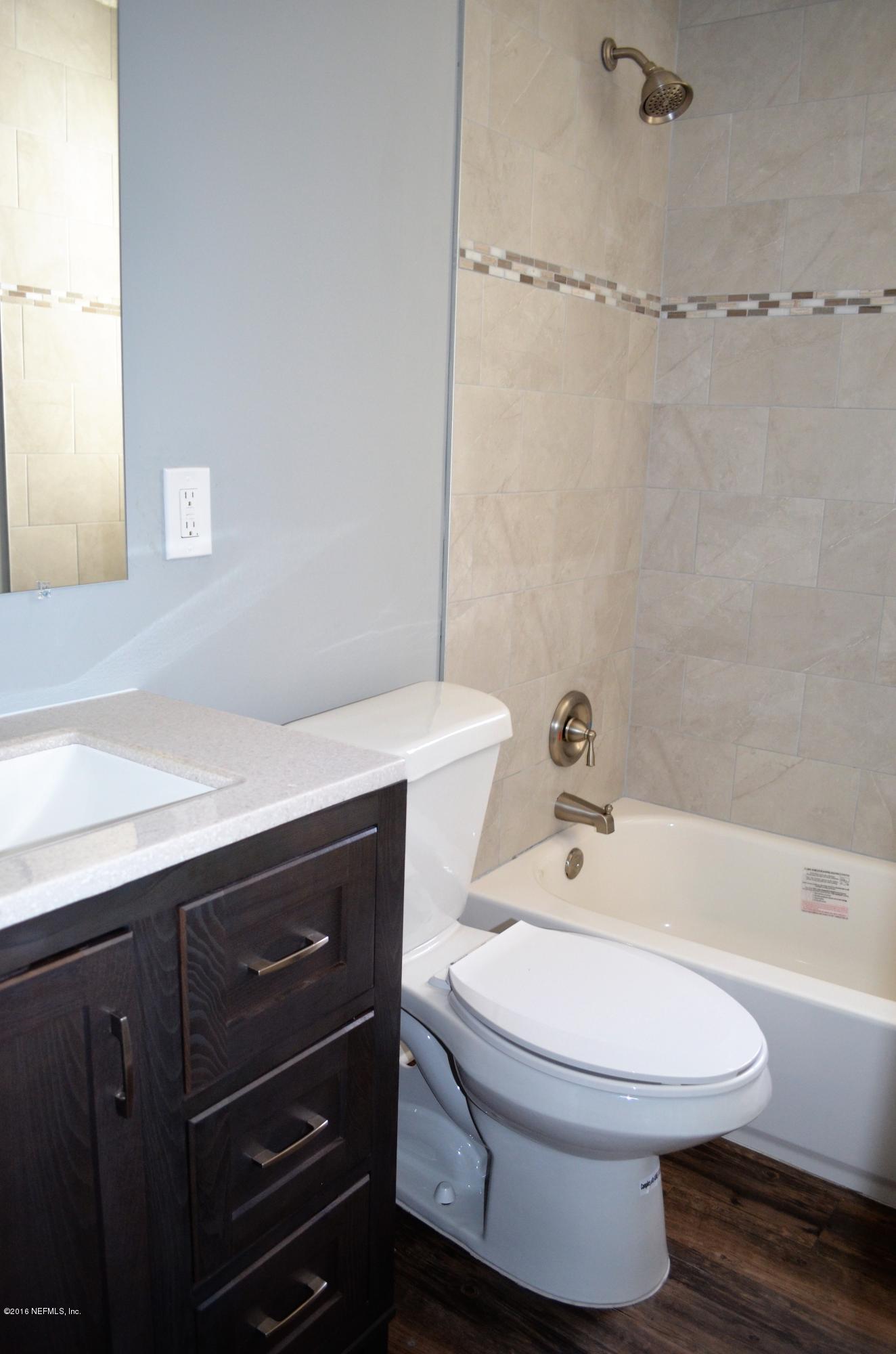 5520 Sabena Road Jacksonville, FL 32207 - Photo 4 of 8 a bathroom with a sink a toilet and shower