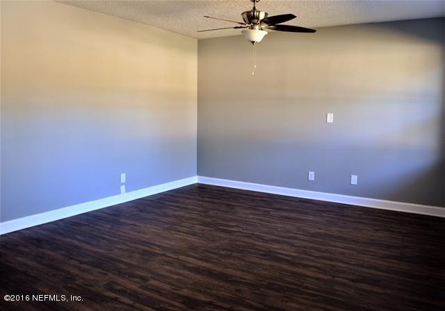 5520 Sabena Road Jacksonville, FL 32207 - Photo 8 of 8 a view of an empty room with wooden floor