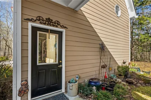 a view of a house with a potted plant and floor to ceiling window and potted plants
