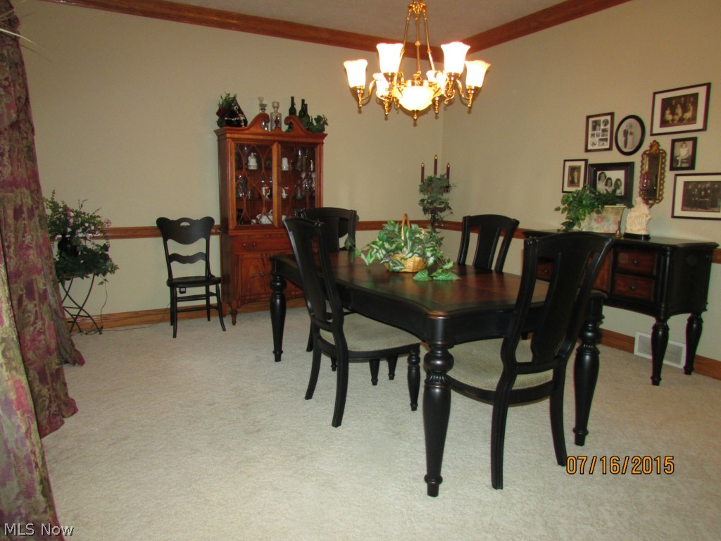 4645 Rock Spring Road Ravenna, OH 44266 - Photo 12 of 25 The dining room has lovely chair rail and crown molding.
