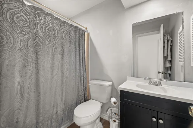 a bathroom with a toilet a sink and a mirror