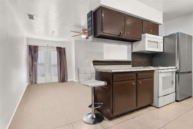 a kitchen with stainless steel appliances a stove microwave and sink