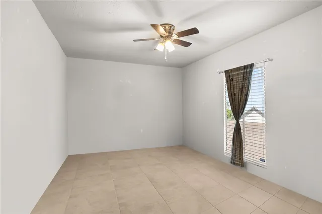 an empty room with closet and fan