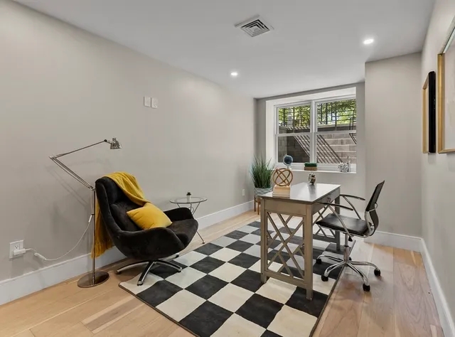 a spacious bedroom with a bed and a large window