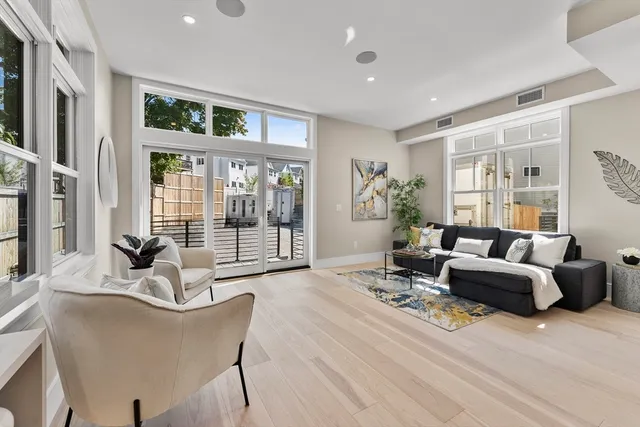 a kitchen with a sink stove and wooden floor