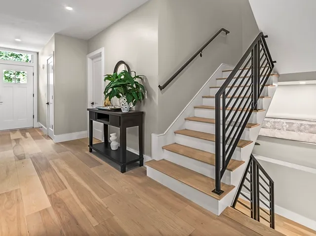 a large white kitchen with lots of counter space wooden floor and appliances