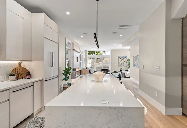 a kitchen with kitchen island a sink table and chairs