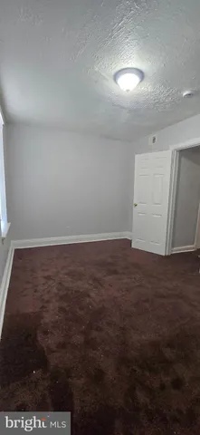 an empty room with wooden floor