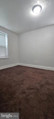 an empty room with wooden floor